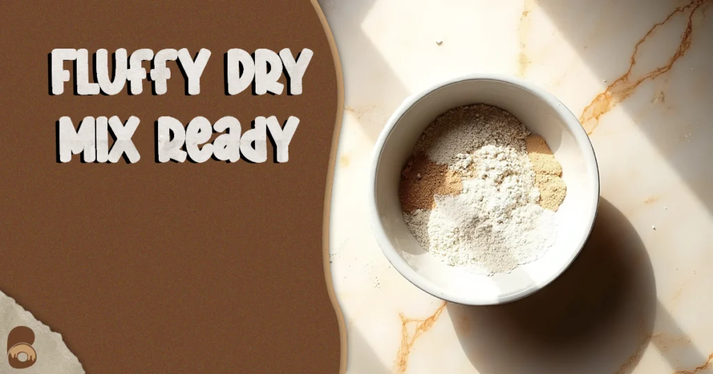 Whisked dry ingredients for vegan vanilla pound cake in a medium bowl on a marble countertop.