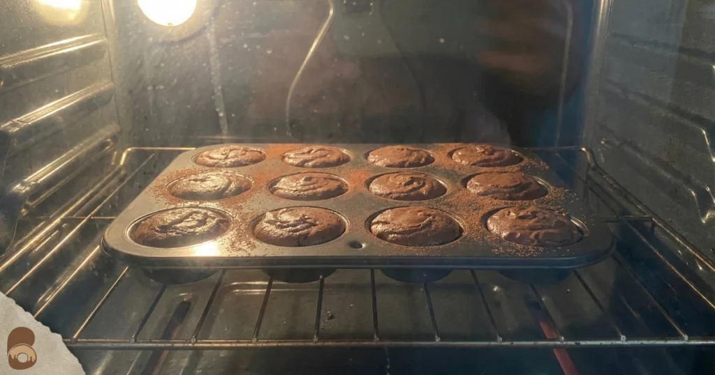 brownie bites baking in home oven with crackly tops and soft centers forming
