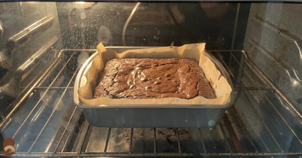 Prime bites brownies baking in home oven with matte edges and soft centers